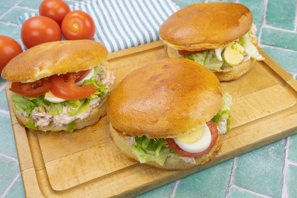 Three tuna bagnat bread on a cutting board