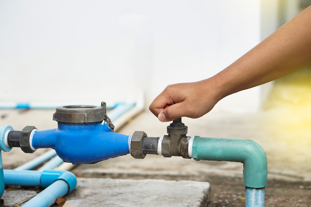 Hand turning off water valve