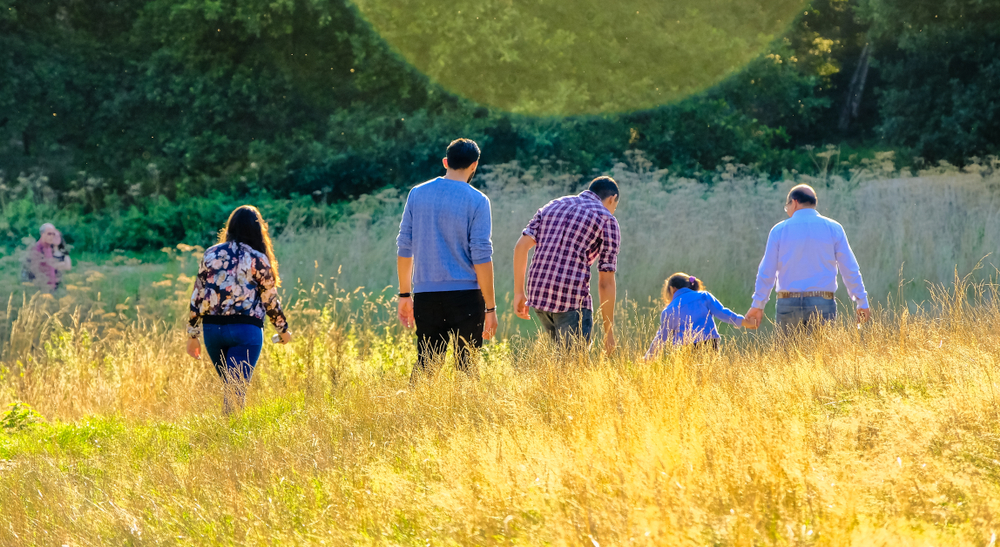 Family members walking through tall grass
