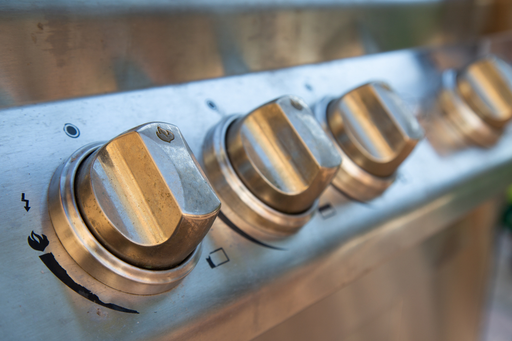 Close-up of temperature dials on a barbecue.