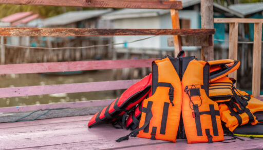 Orange lifejacket on pile of lifejackets