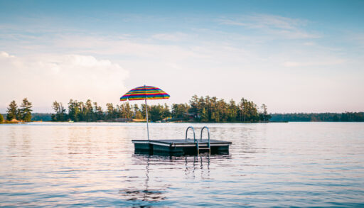 Colourful umbrella on floating dock in middle of lake