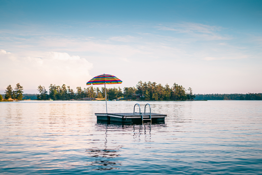 Colourful umbrella on floating dock in middle of lake