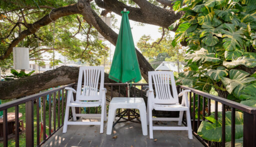 White plastic patio chairs on back porch