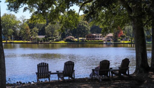 Four lawn chairs on beach