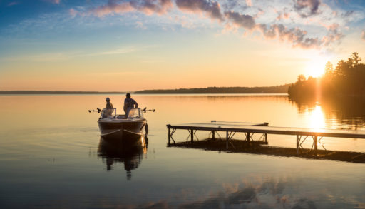 Cottage Life - Father and son fishing on a boat at sunrise/sunset at the peaceful cottage in Kawartha Lakes Ontario Canada on Balsam Lake