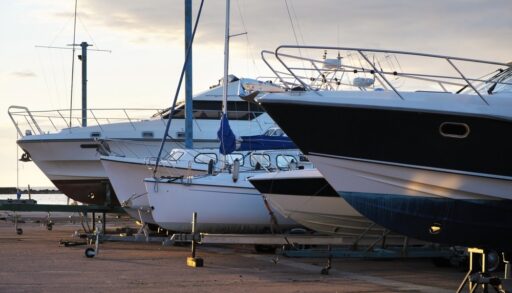 Close-up of boats for sale lined up along a dock.