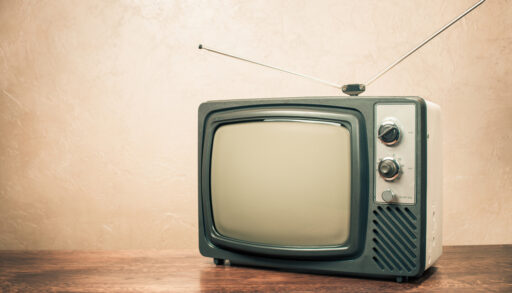 Retro television sitting on a table.