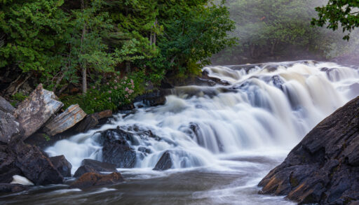 Egan Chute, Ontario surrounded by a green forest.