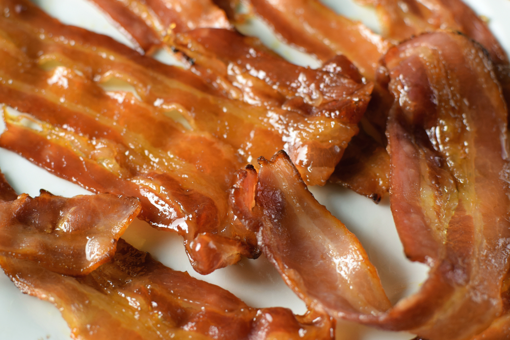 Close-up of candied bacon on a plate.