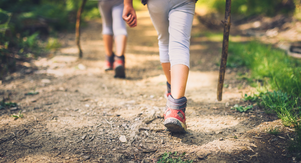 Close-up of children's feet while hiking.