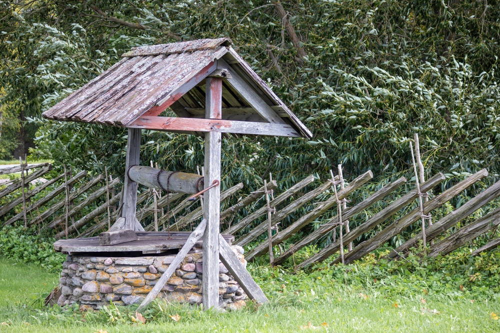 Wooden water well in a forest.