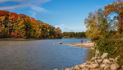 Lake surrounded by red and orange-coloured trees.