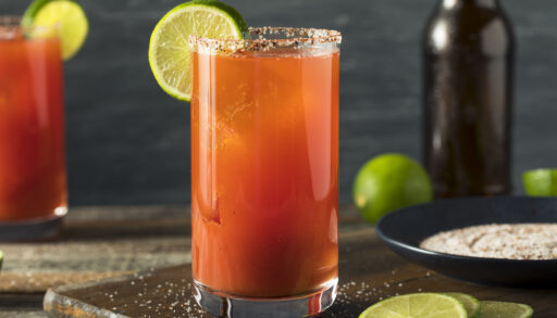 Homemade Michelada on a wooden serving board.
