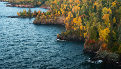 Aerial view of fall foliage along the shore of Lake Superior.
