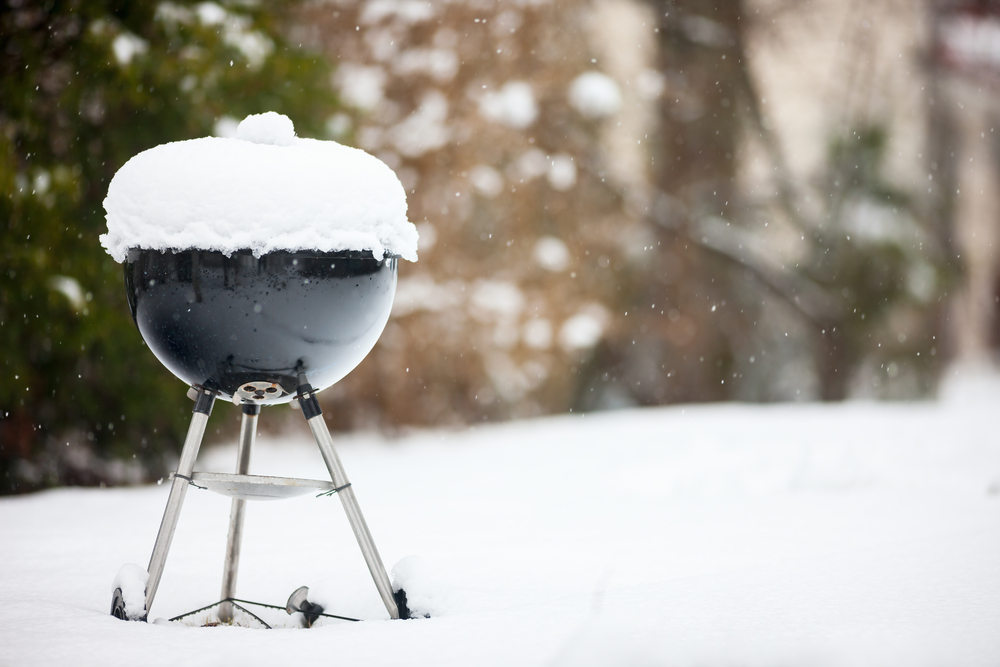 Black grill covered in snow.