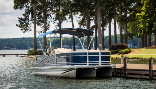 Pontoon boat anchored next to a private dock.