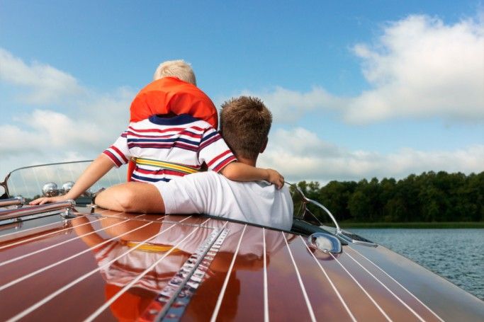 Father and son on speedboat