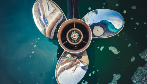 Close-up of three blades on a boat engine.