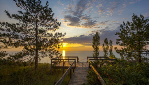 Boardwalk leading to a beach in Pinery Provincial Park at sunset.