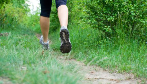 Woman cross country running on trail