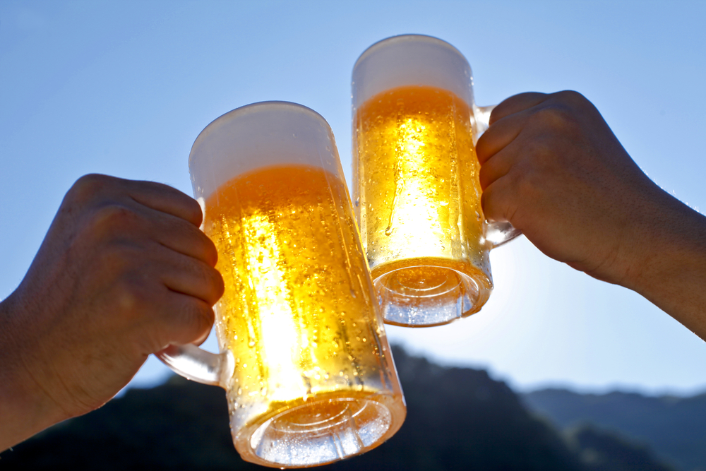 Two people raising beer glasses.