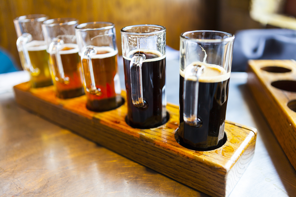 Line of beers on a tray.