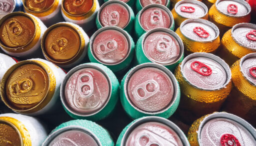 Rows of different-coloured beer cans.