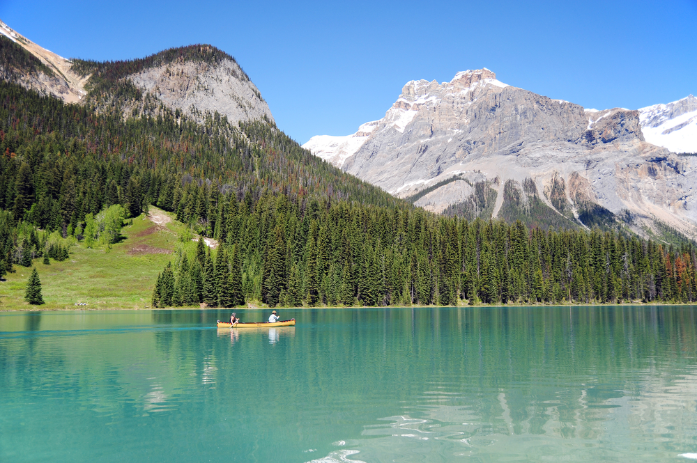 People in a canoe on Emerald Lake, Banff, Alberta, Canada.