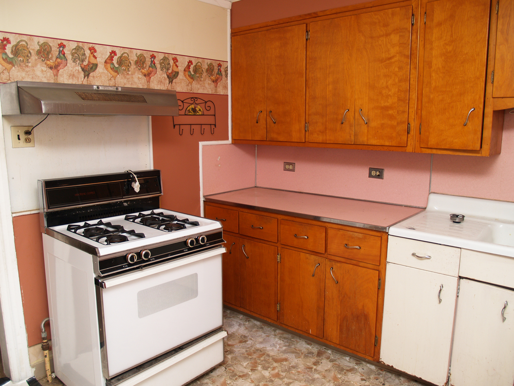 old kitchen with older appliances and wood cabinets