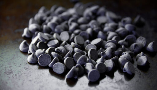 Close-up of chocolate chips poured on a table.