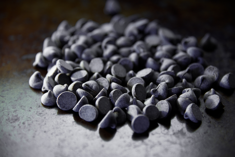 Close-up of chocolate chips poured on a table.
