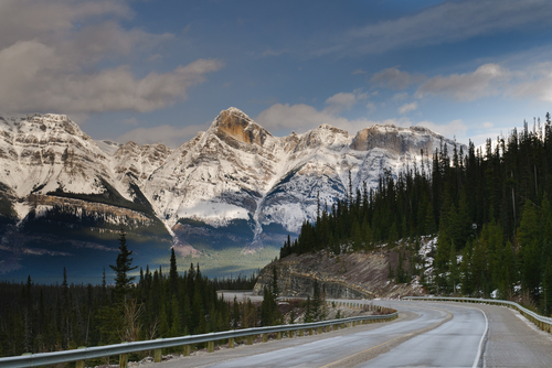 Road along the Icefields Parkway mountains in Alberta, Canada.