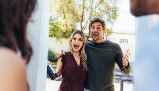 Young man and woman arriving at a friend's house.
