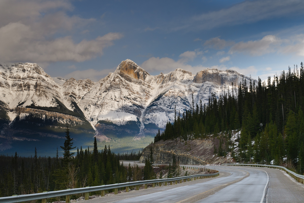 Road along the Icefields Parkway mountains in Alberta, Canada.
