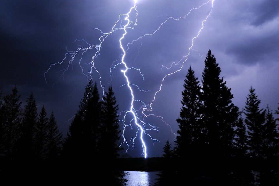 Lightning strike illuminates the night sky over Morin Lake, Saskatchewan.