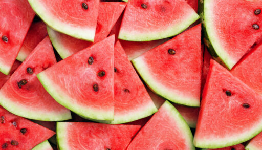 Close-up of pink watermelon slices piled on top of one another.