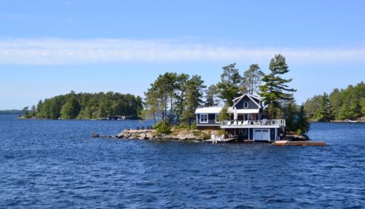 Brown cottage on an island on Lake Muskoka.