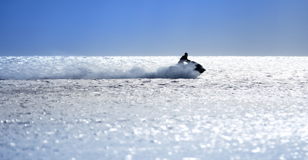 Person riding a jet ski on open water.