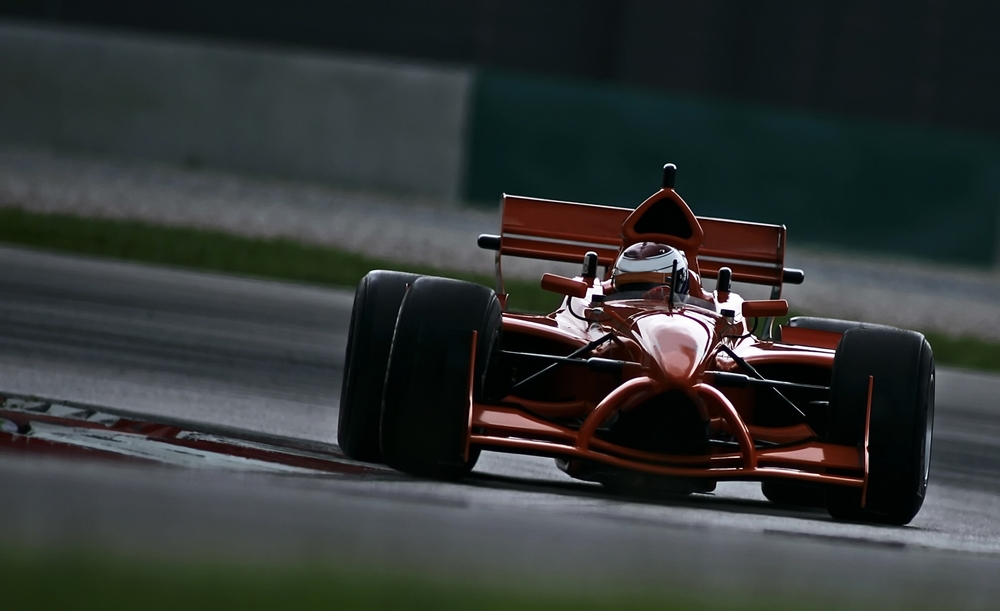 Close-up of a person driving a Formula 1 car.