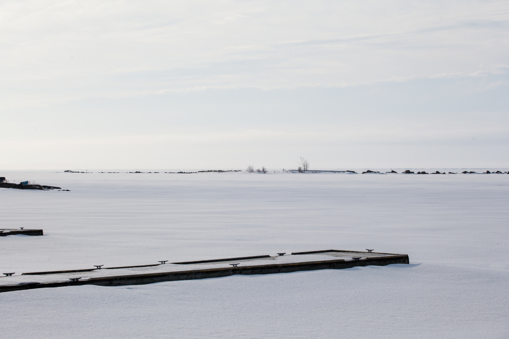 Wooden docks in a frozen Lake Huron.