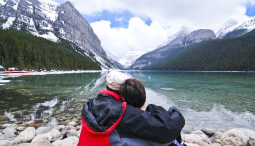 A couple sitting by Lake Louise in Banff, Canada.