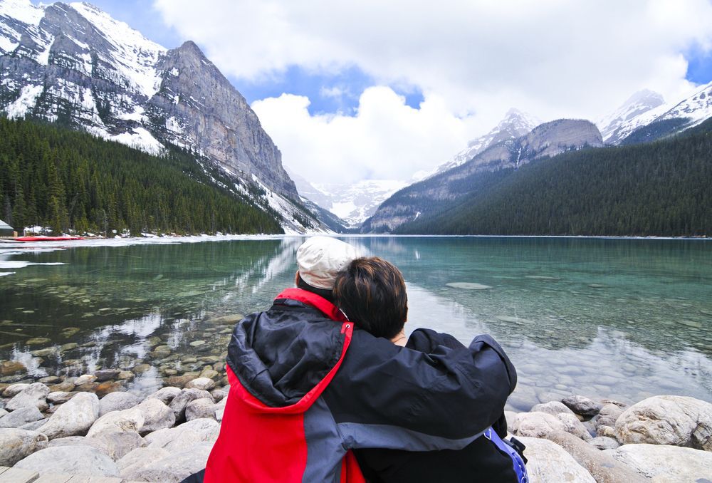 A couple sitting by Lake Louise in Banff, Canada.