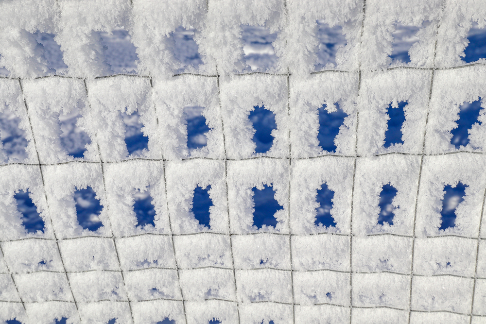 Close-up of rime ice on a metal fence.