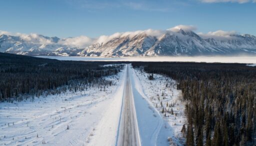 Road running towards the mountains in Whitehorse, Yukon.
