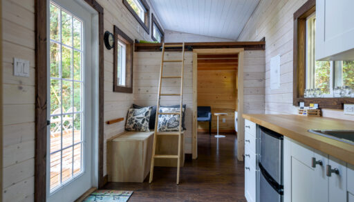Interior of a tiny house with a loft.