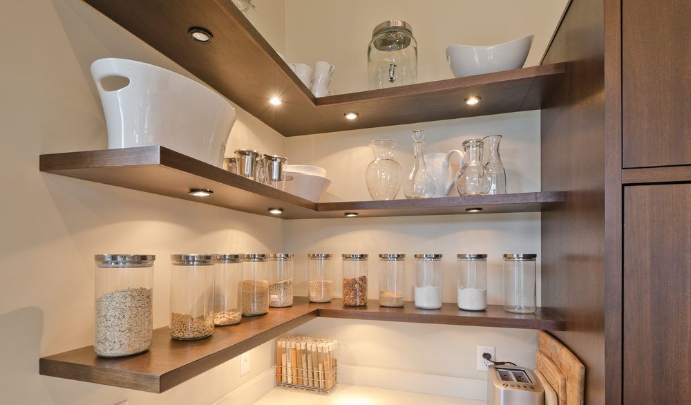 Brown kitchen shelving with differently sized jars and containers.