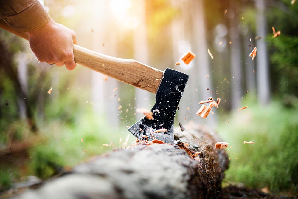 Close-up of an axe chopping wood.