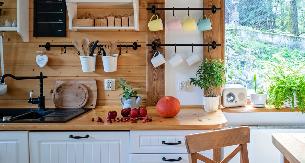 Small kitchen with white cabinets and wooden countertops.