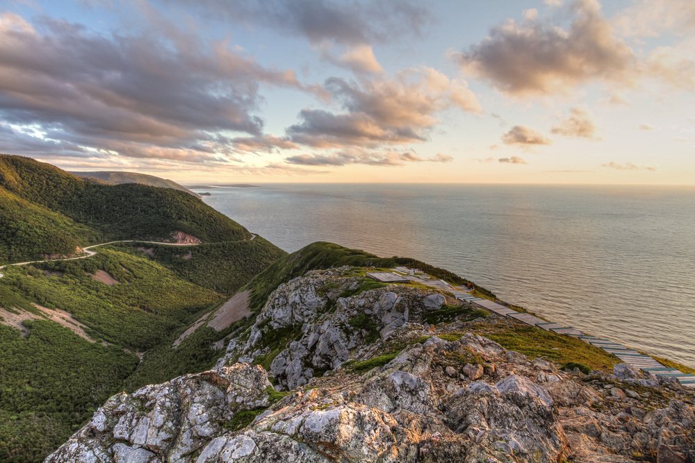 Rocks covered in grass near the ocean along The Cabot Trail, Nova Scotia.